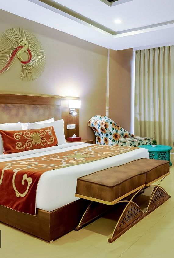 Image of a room with bed and a fancy decor piece above it at Summit By The Ganges Beach Resort & Spa, Rishikesh