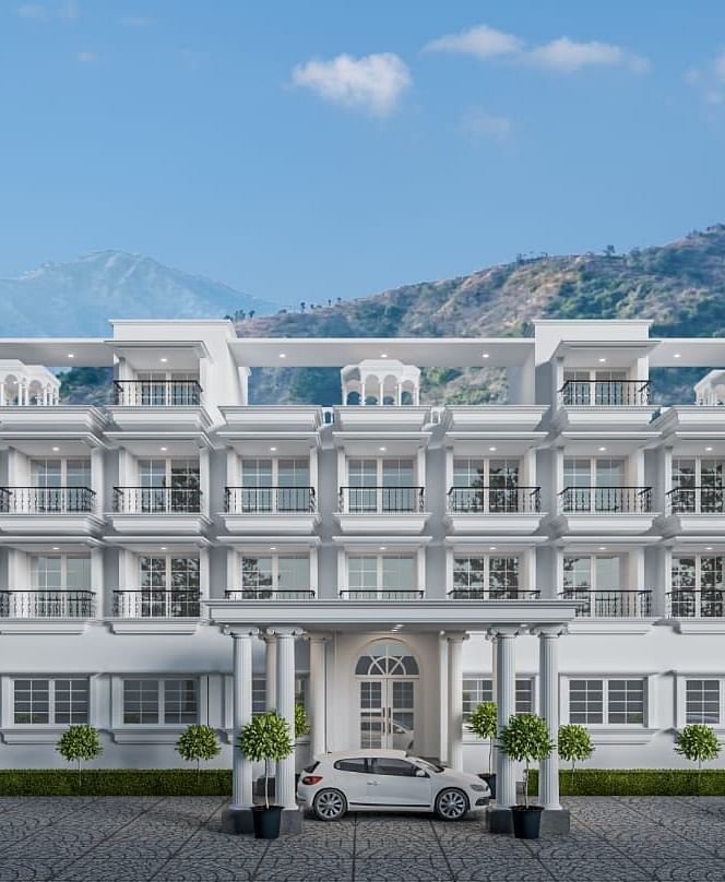 Front view shot of the facade of Namaste Corbett with beautiful mountains in the background.