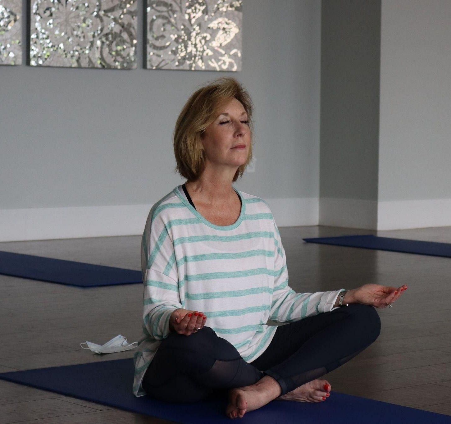 An elderly woman meditating.