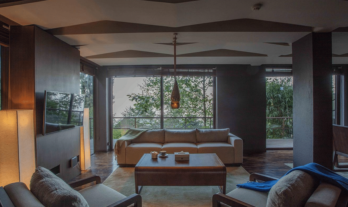 Natural light flooding a living room which has to couch and a centre table | Kavya Resort and Spa, Nagarkot