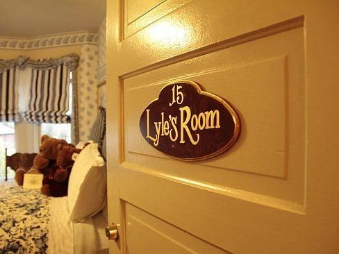 A door to a hotel room with signboard that says Lyle's Room attached to it - The Groveland Hotel.