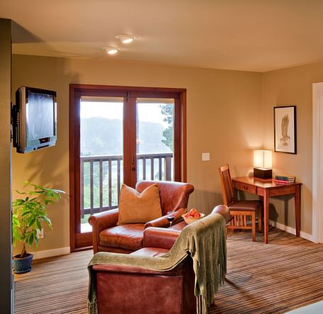 A cosy room in Mendocino with warm lighting, plush seating, and scenic views - Brewery Gulch Inn & Spa