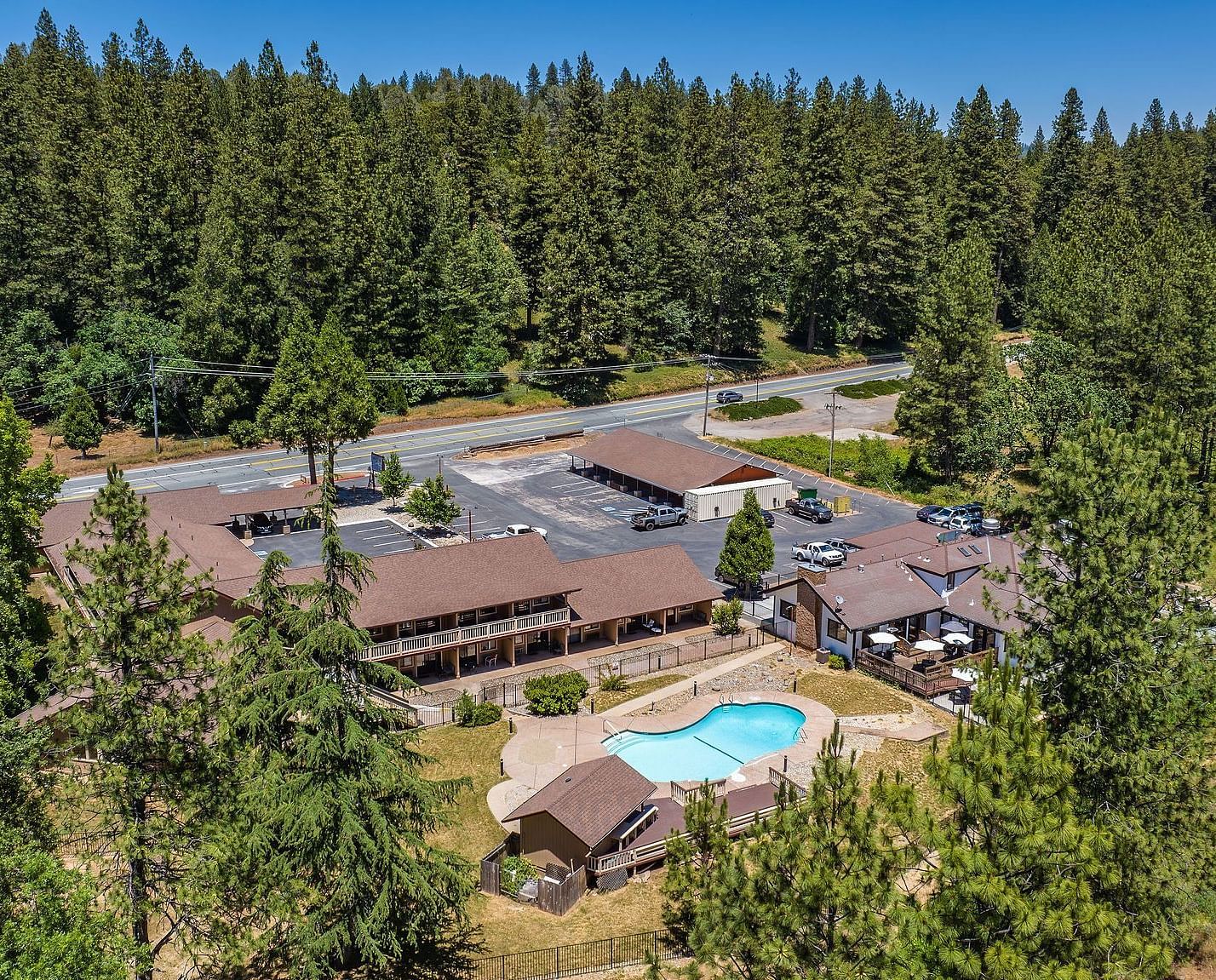 An aerial view of Amador Hotel with a forest in the backdrop