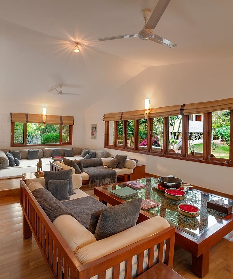 The living room space of the 3-bedroom cottage at Shreyas Retreat with sofa seating and coffee table arrangement