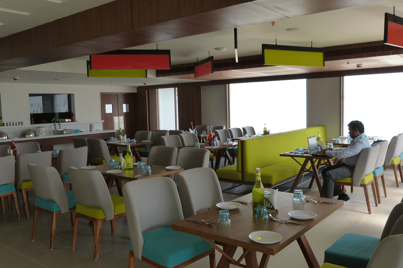 The dining area has chairs and tables arranged neatly for the guests