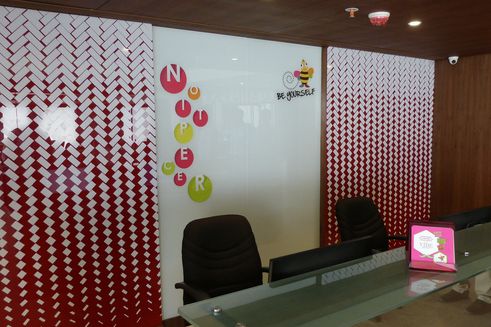The reception area features a desk with chairs arranged neatly around it