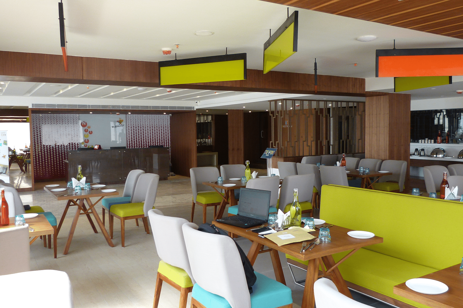 The dining area is set up with tables and chairs arranged neatly for the guests