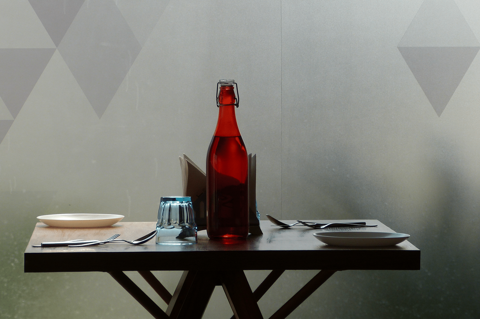  The dining area table is neatly set with cutlery, ready for the guests