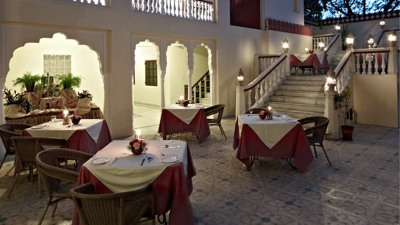 Outdoor seating in the courtyard at anada restaurant at Mandawa Haveli, Jaipur
