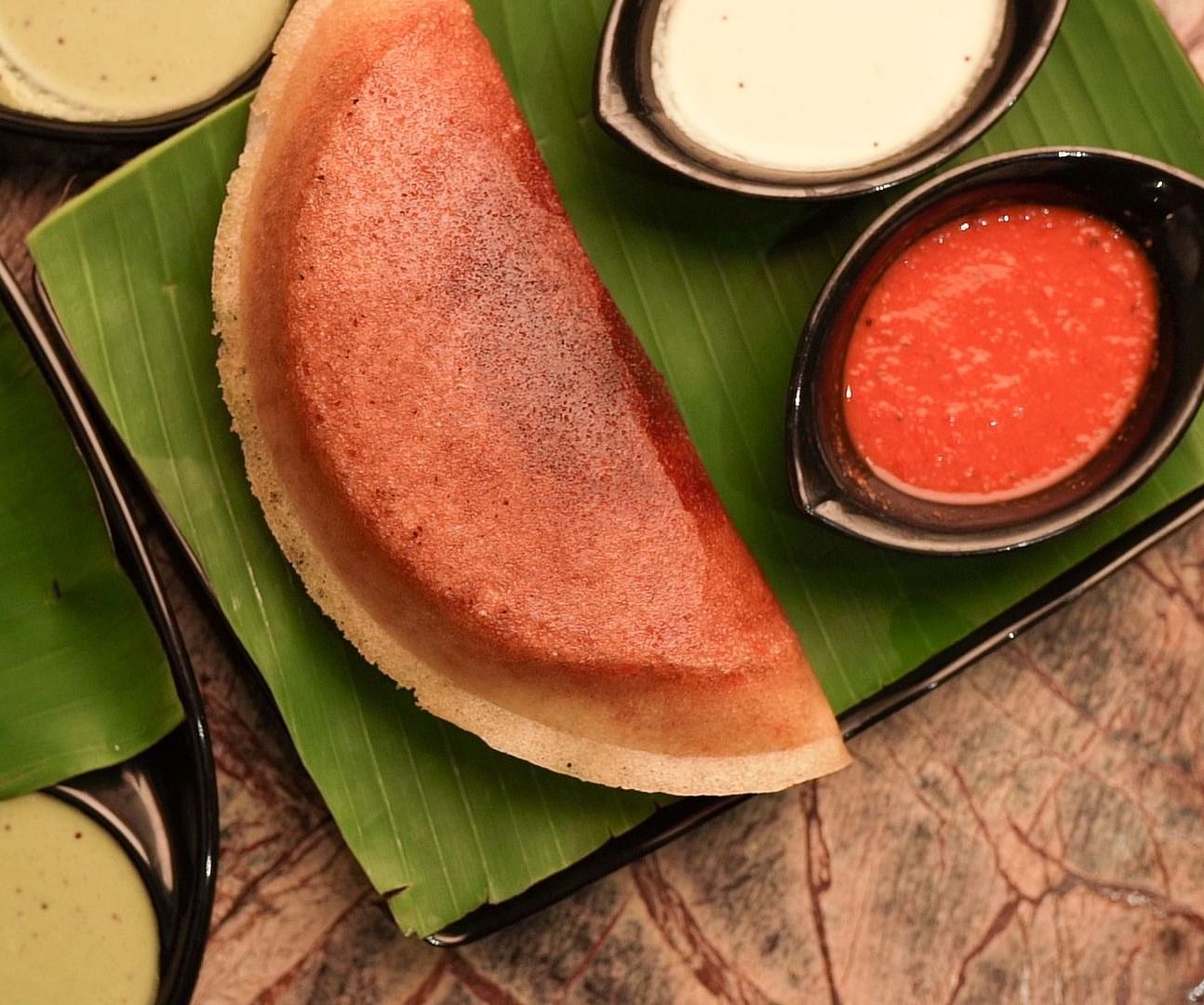 An image of dosa served with curd and pickle - Pai Group of Hotels