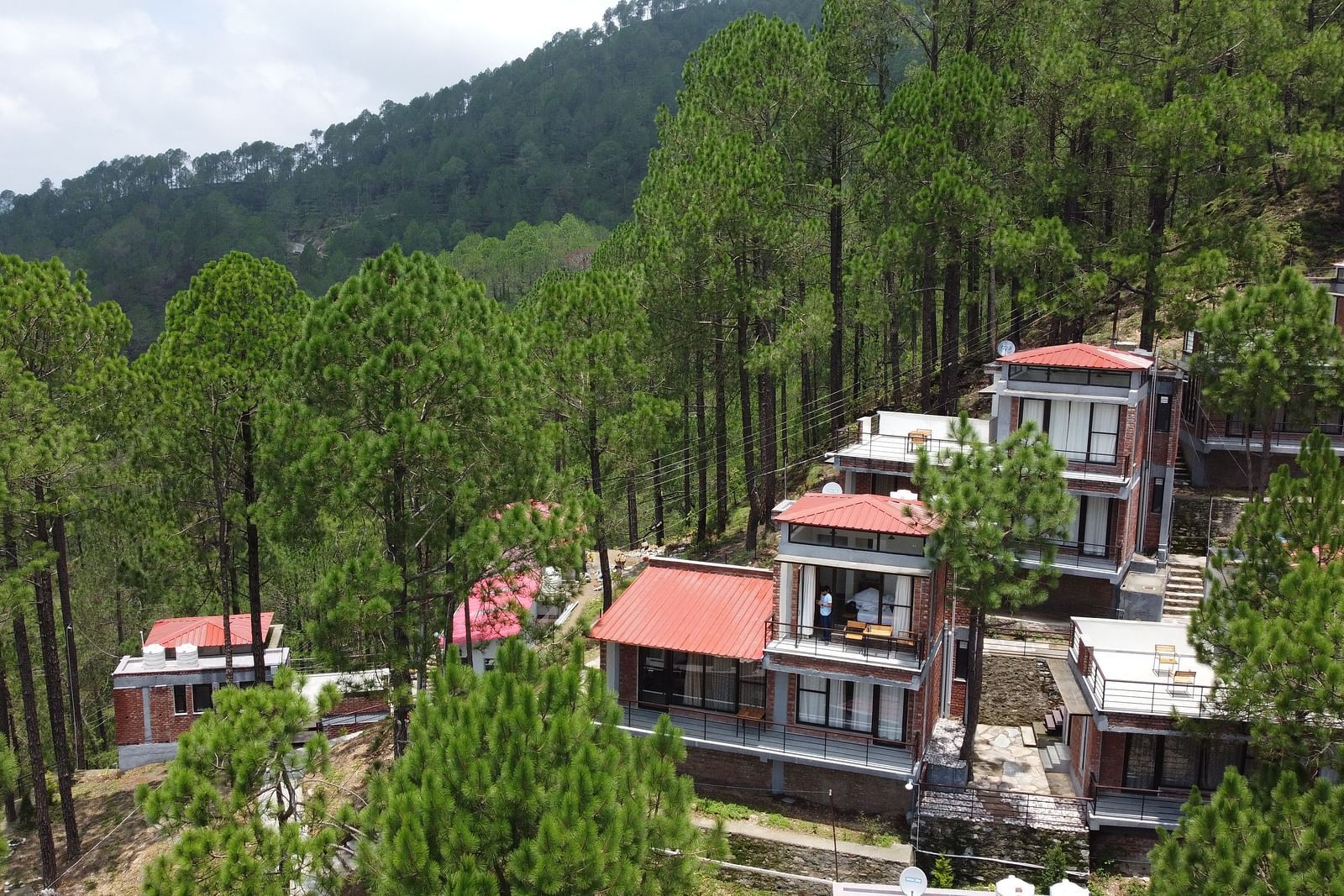 Facade of BluSalzz Escapade Resort, Lansdowne, showcasing its modern architecture and scenic surroundings.