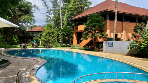 A view of an outdoor swimming pool near the cottages at Abad Abad Green Forest, Thekkady