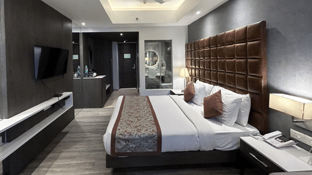 An interior view of a bedroom looking towards the entrance, featuring a double bed and a ceiling fan | Sand Heaven