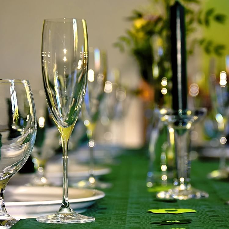 champaige glasses and plates set on a table