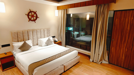  A well-furnished bedroom at Smith Balcony Villa with a double bed, soft lighting, and access to a balcony area