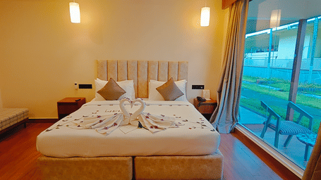 A bedroom at Ross Villa offering a scenic outdoor view through large glass windows