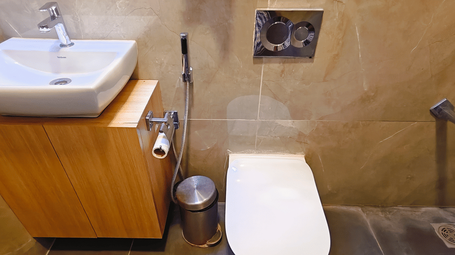 A compact bathroom at Barren Villa with a modern washbasin, toilet, and shower area