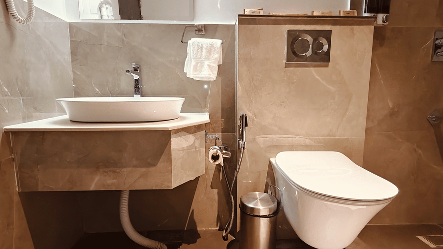 A modern bathroom at Smith Balcony Villa with a vanity counter, toilet, and tiled walls