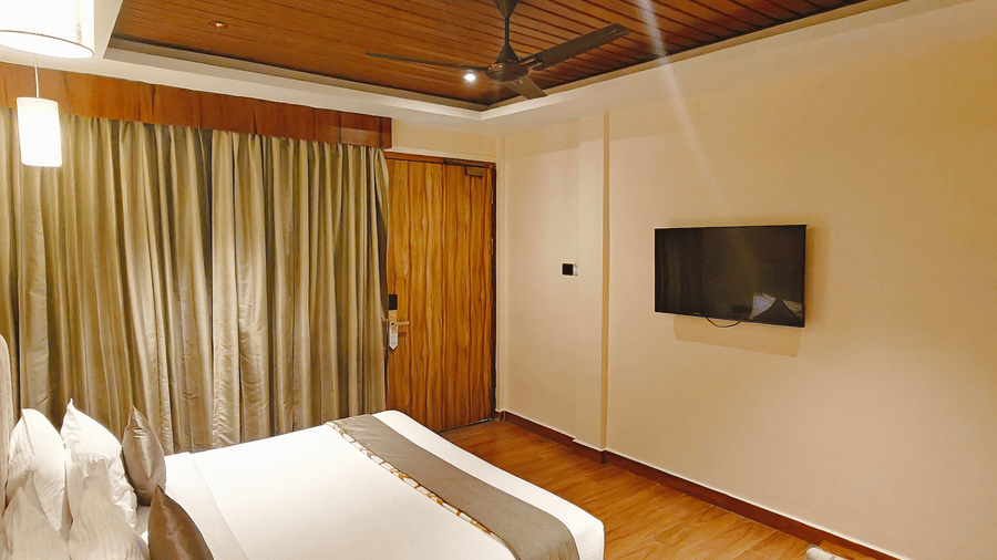 A spacious bedroom at Red Skin Villa with a comfortable bed, TV, and elegant lighting
