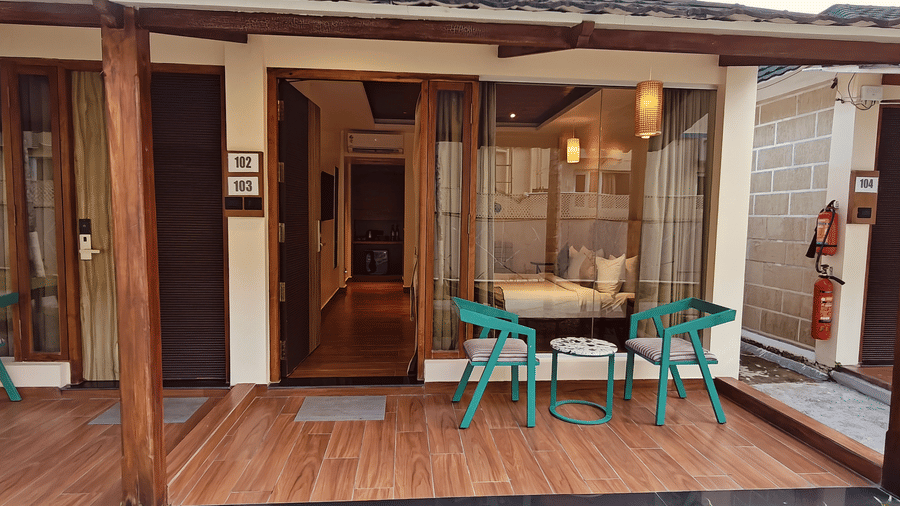 An outdoor seating area at Red Skin Villa with wooden flooring and multiple patio chairs