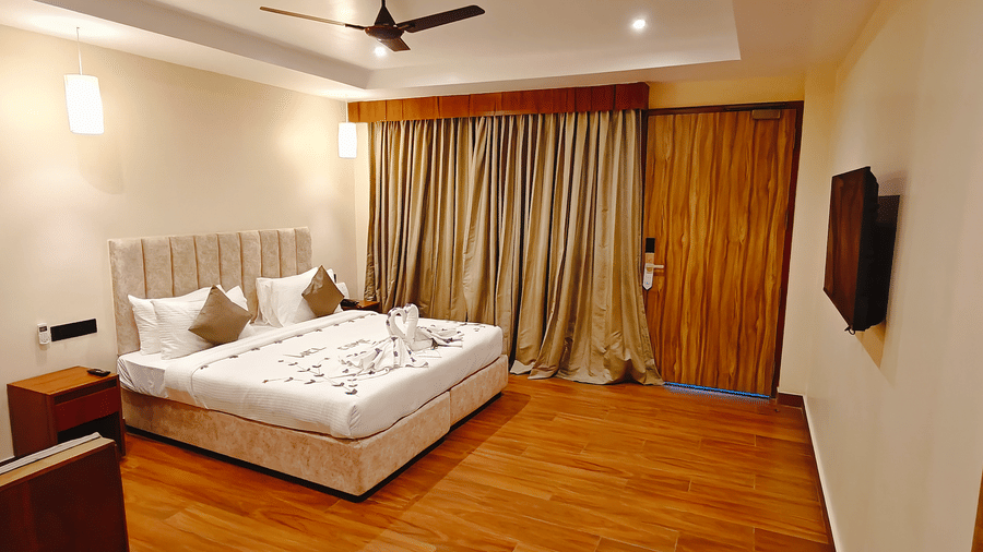 A warm bedroom at Ross Villa with a comfortable bed, wooden flooring, and soft lighting