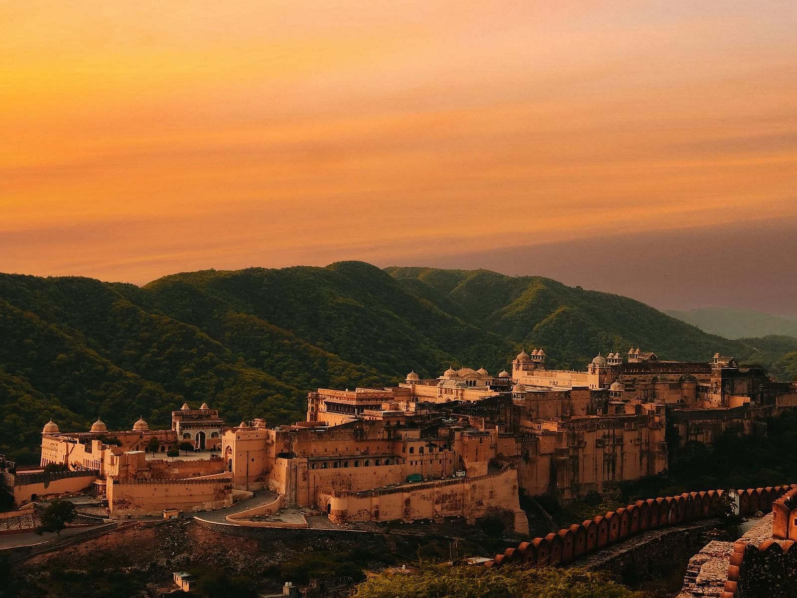 Aerial view of Amber Fort with mountains in the background.