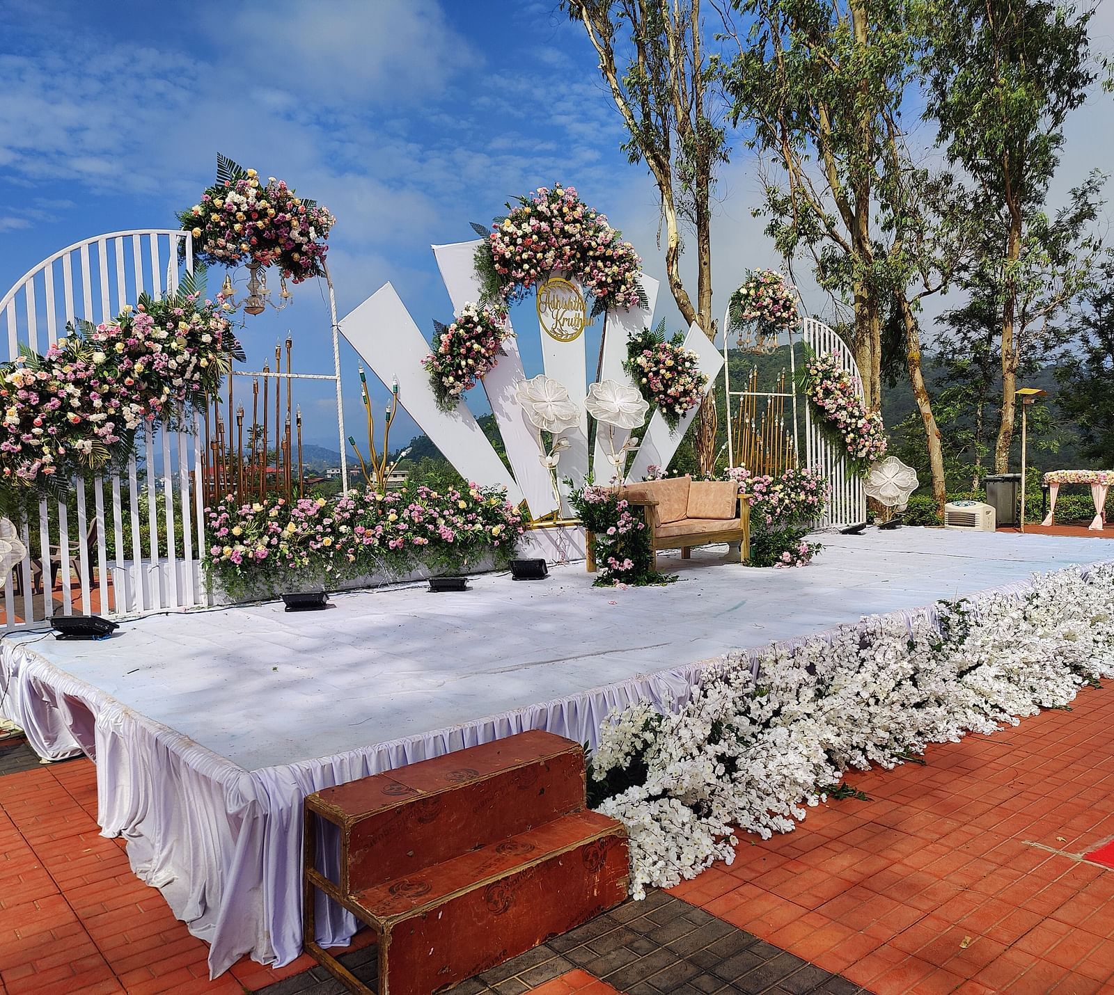 Outdoor reception area with decorated tables and floral backdrops | Open Deck