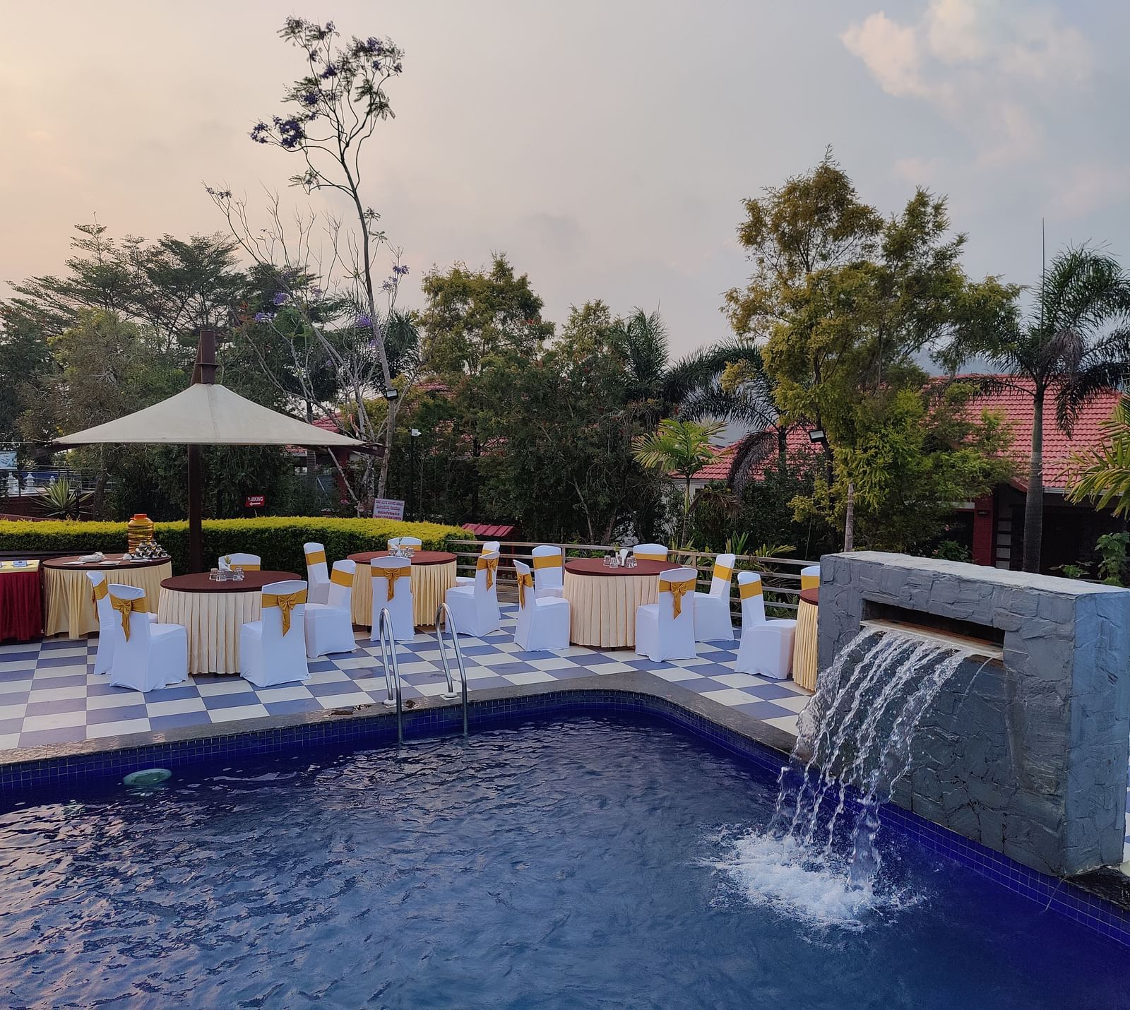 Outdoor event space featuring a pool and seating areas | Open Deck | Woodstock Resorts, Coorg