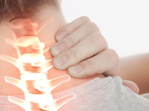 A person grasps the back of their neck, with a glowing, X-ray-like overlay highlighting the cervical spine and pain.