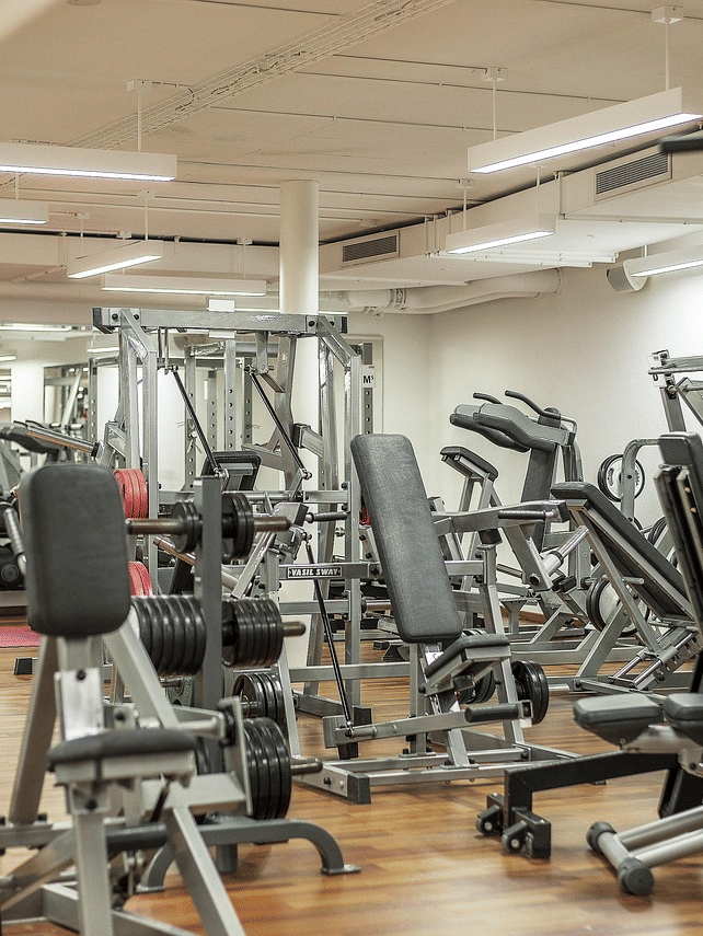 A well-equipped modern gymnasium with various exercise machines included in the Ranthambore Resorts Facilities.