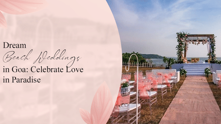 Dream beach wedding setup in Goa with a floral mandap on a raised platform, overlooking the ocean, and clear chairs with pink accents.