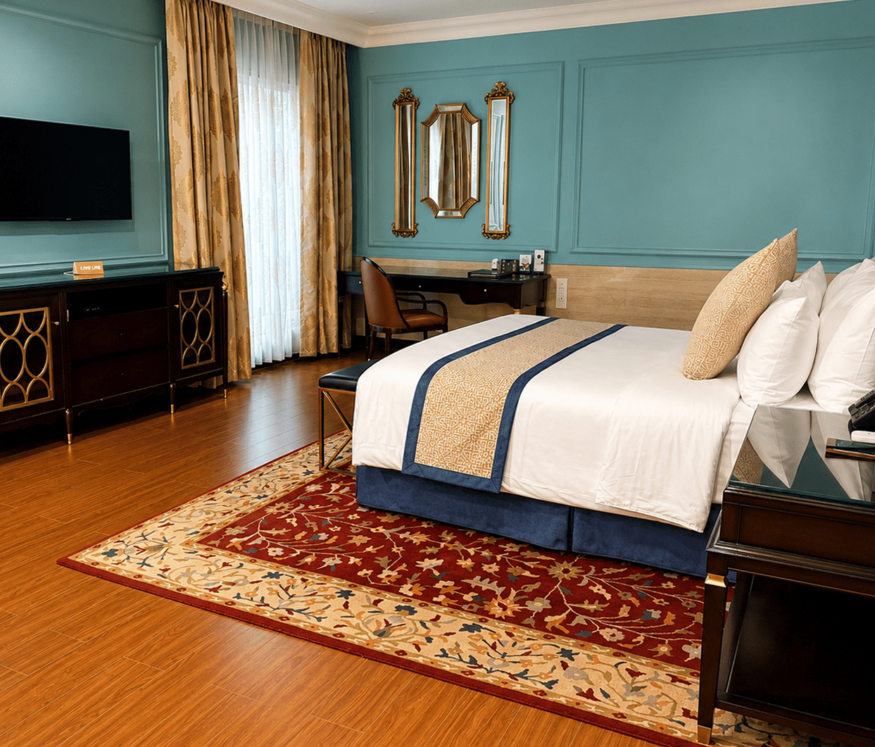 Junior Suite bedroom with teal accent walls and wooden flooring at MAYFAIR Lake Resort, Raipur