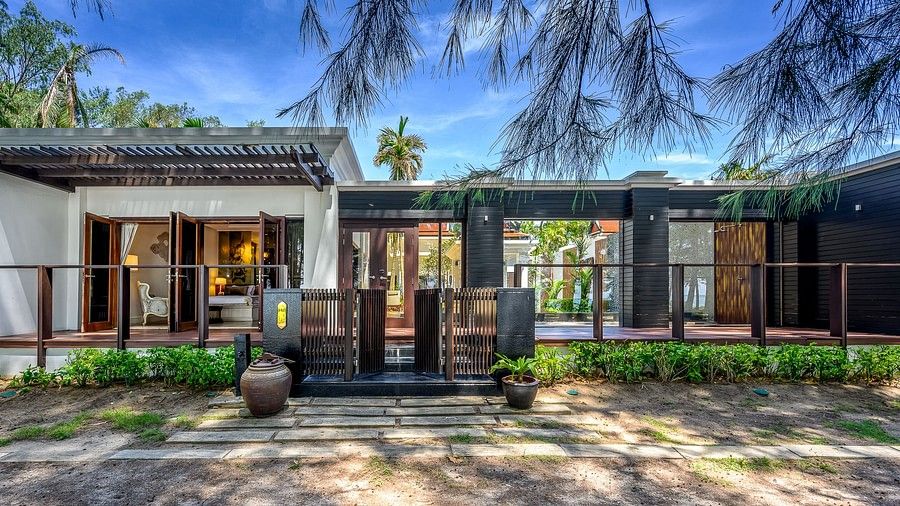 exterior image with stone pavements in the foreground - one bedroom private pool beachfront villa