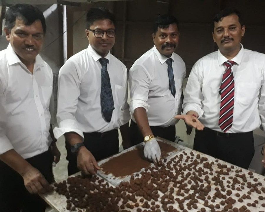 people surrounding the seeds laid out on a table