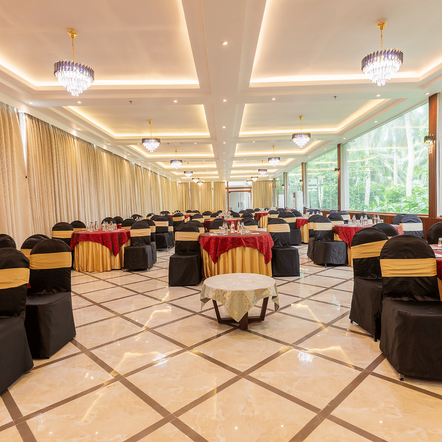 Dining area with round tables and bright interiors at Silver Sand Sea Princess Beach Resort, Port Blair.