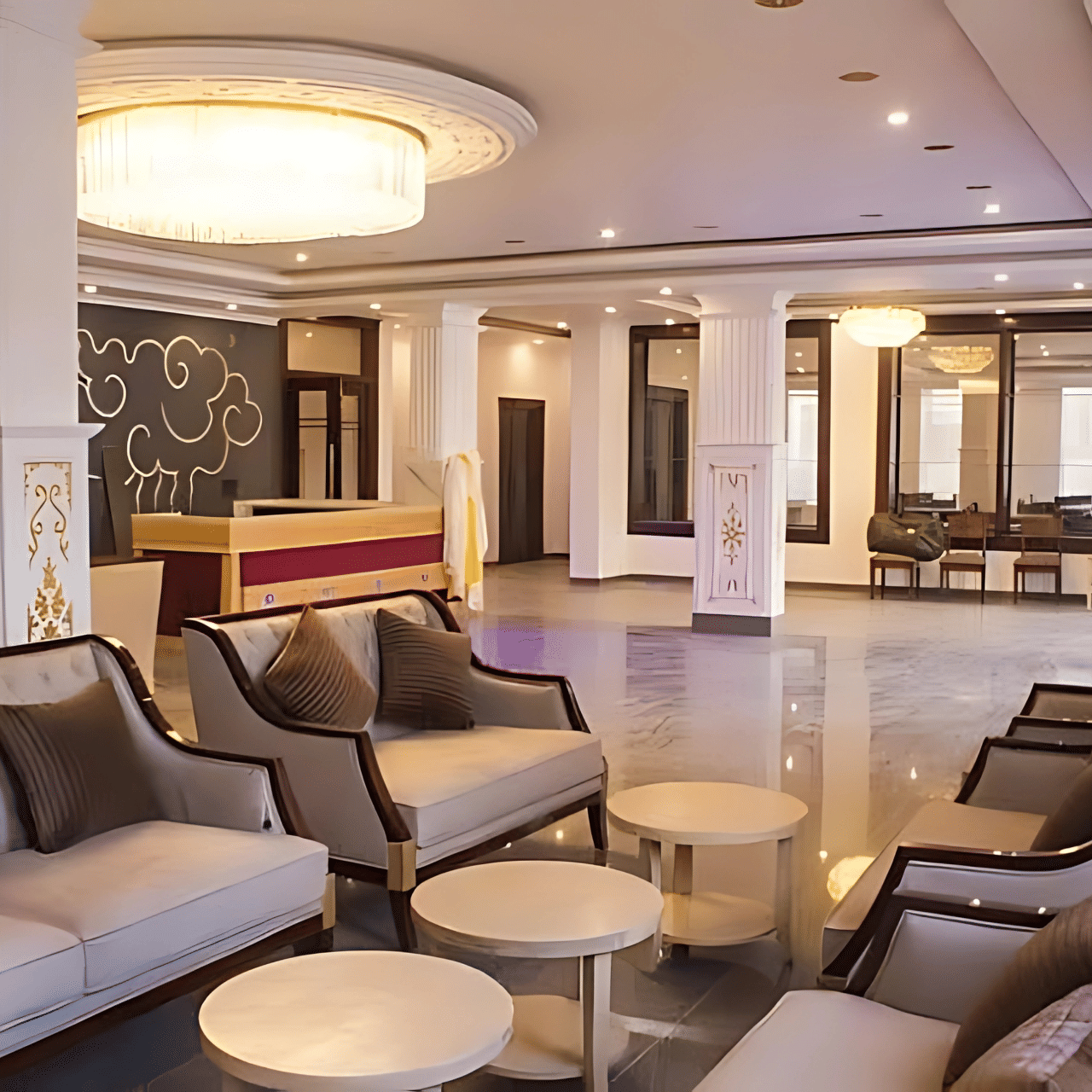 The main lobby of Hotel Dekiling by Eastlynn Collections, Leh showing a reception desk, plush seating arrangements, and a large circular ceiling light.
