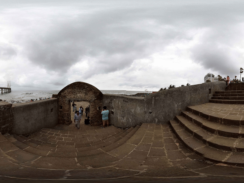 A panoramic view of the Bandra Fort with the Bandra-Worli sealink bridge on the left and steps leading to the view point on the right. It is one of the best places to visit on your monsoon getaway (Mumbai).