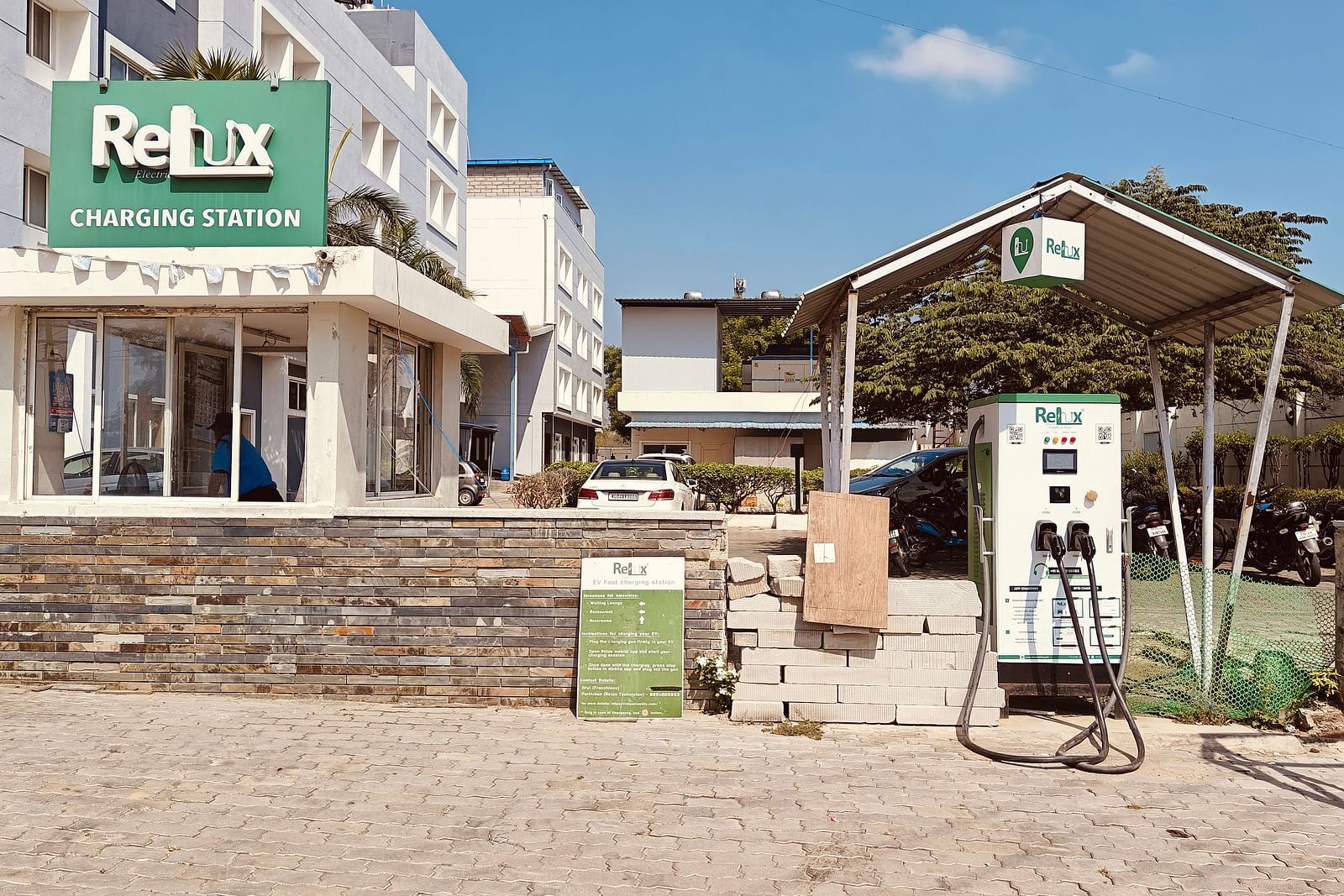 Front view of the entrance and signage of Hotel Alps Residency, Krishnagiri, during daytime.