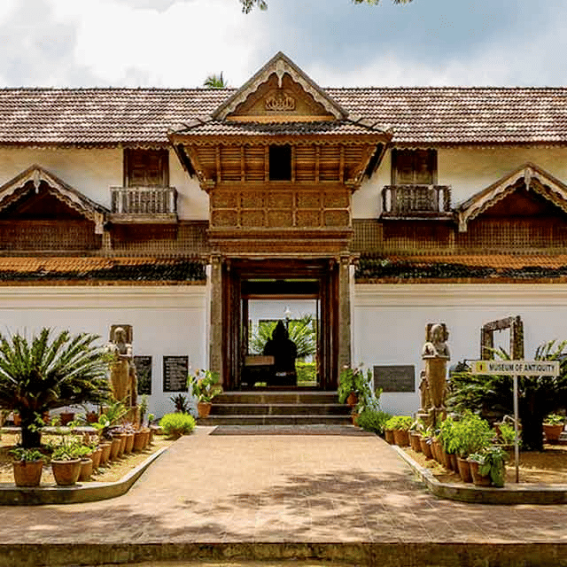 A heritage-style building with ornate wooden details and a landscaped entrance.