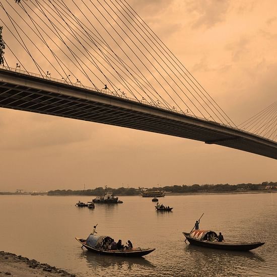 view of the howrah bridge and river hooghly running under it