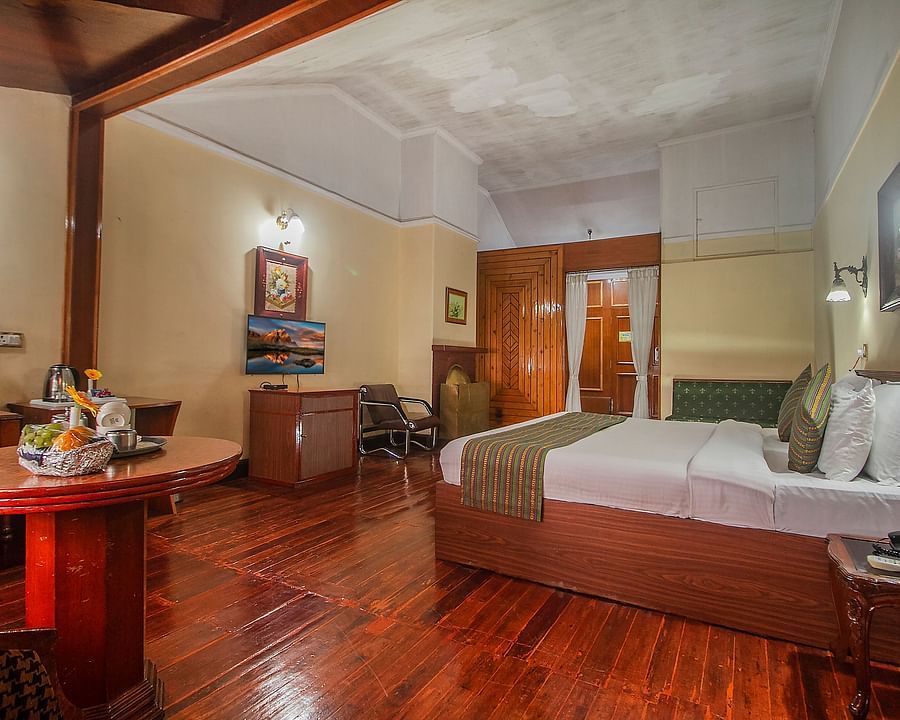 Heritage Club King Room at Central Heritage Resort & Spa, The Mall, Darjeeling - a spacious and elegant accommodation with classic decor and wooden flooring.