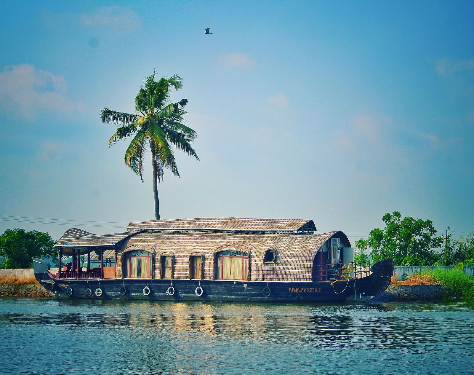 A houseboat passing by in a lake.