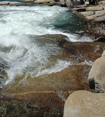 Rushing water cascading over rocks in a river.