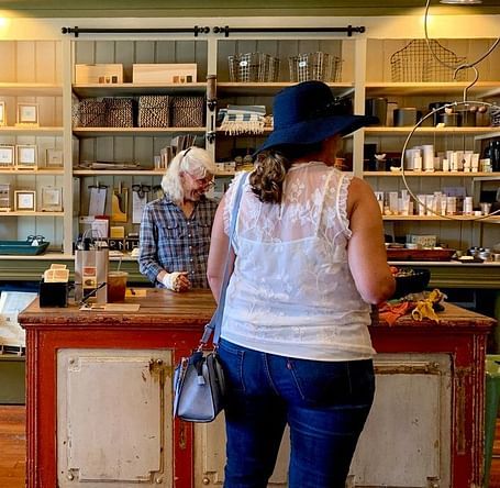 An image of a souvenir shop where one person is behind the counter.