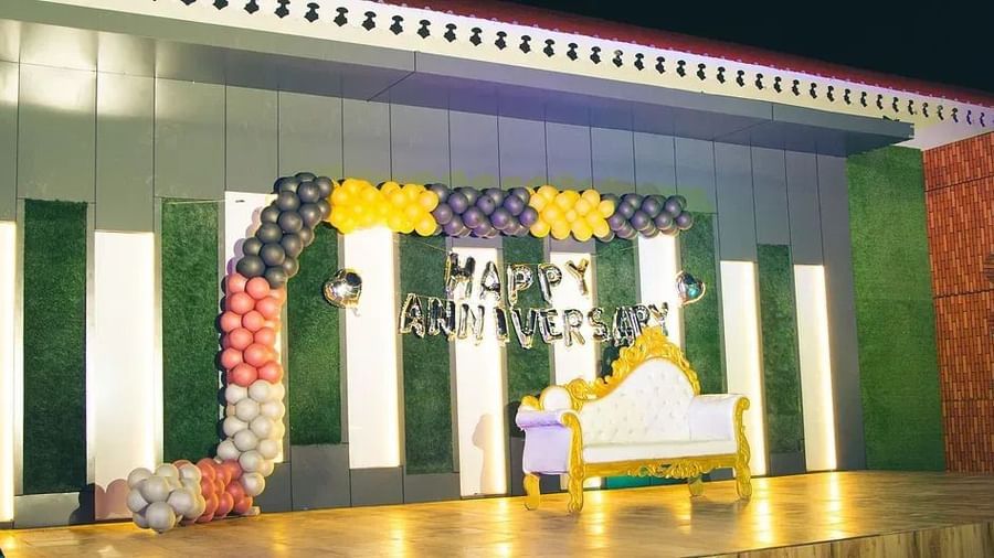 A well-lit stage setup with colourful backdrops for an event at Daksh Resort and Amusement Park.