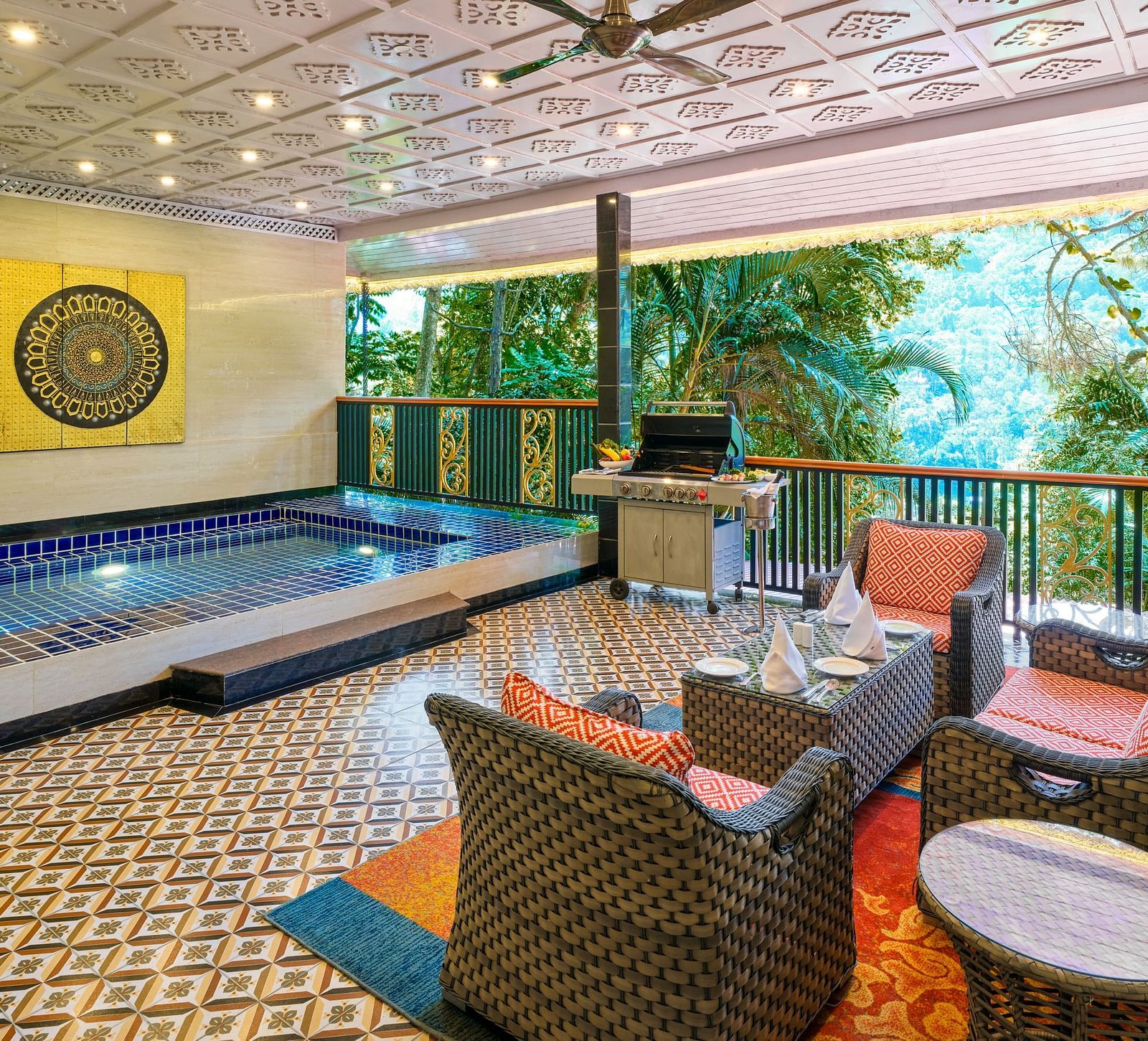 Crown Villa Pool with a seating area and a balcony overlooking greenery.