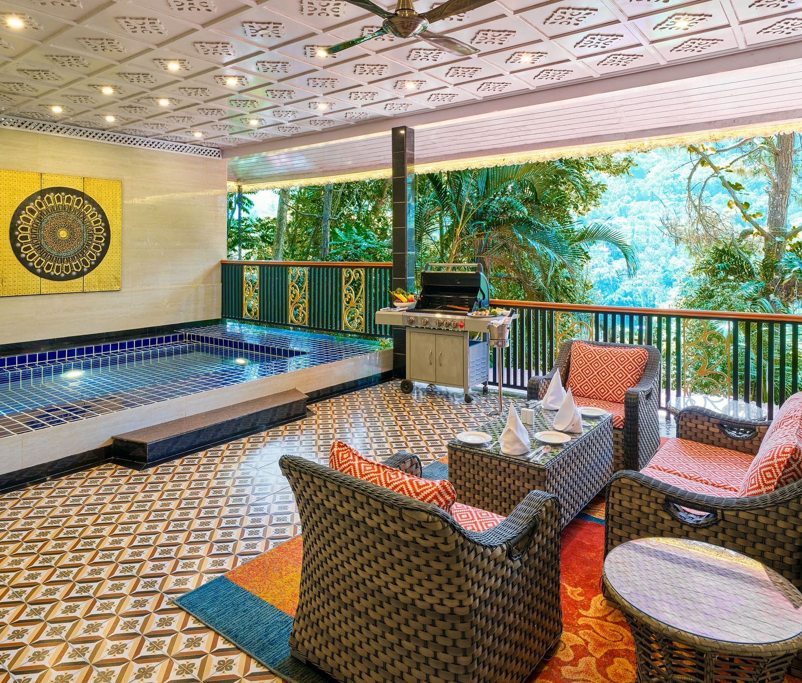 Crown Villa Pool with a seating area and a balcony overlooking greenery.
