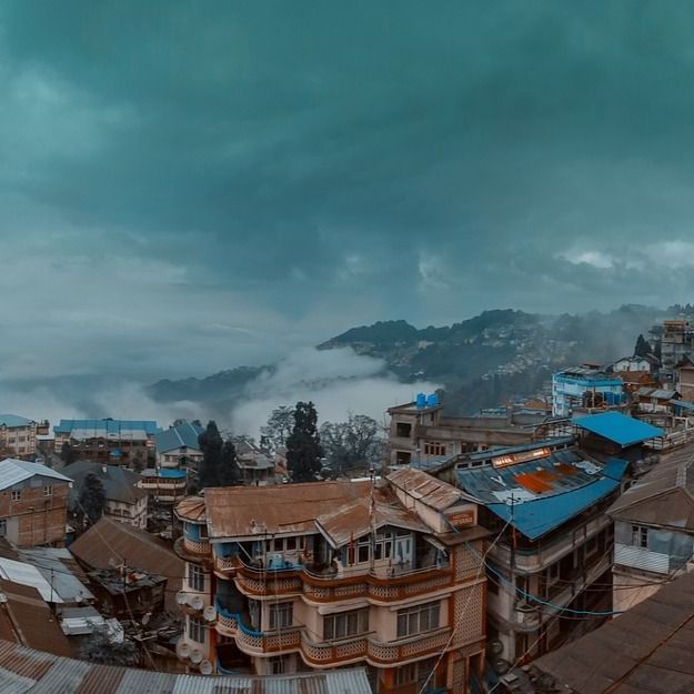 a serene landscape of darjeeling with a cloudy backdrop