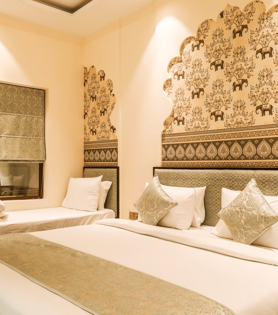 Bedroom with double bed, headboard design, and side tables at Beelwa Palace, Jaipur