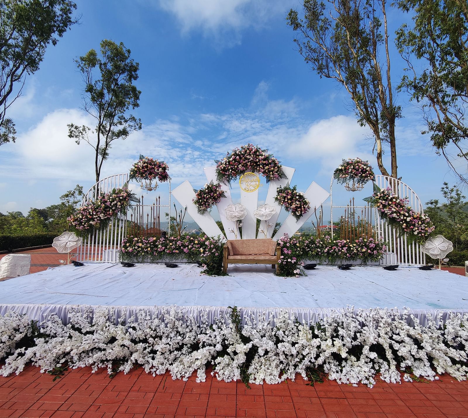 Outdoor wedding setup with white floral arrangements and seating | Open Deck